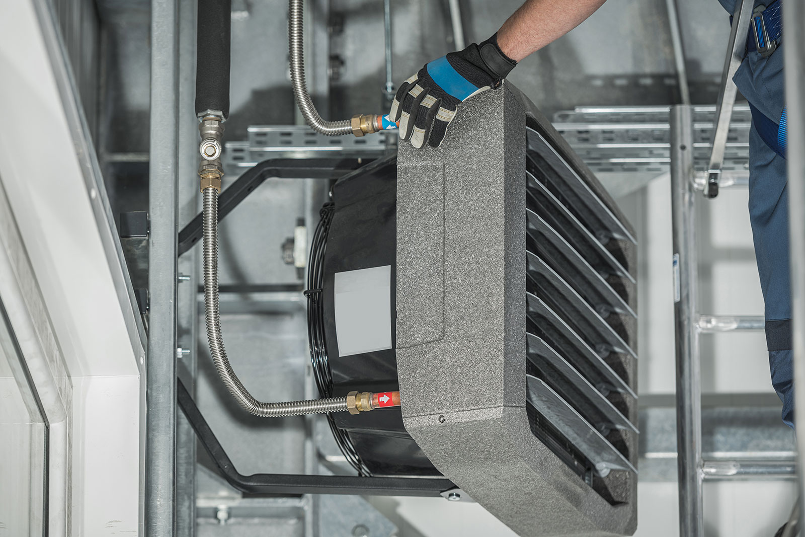technician-servicing-warehouse-heating-unit-attached-building-wall.jpg